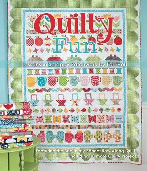 Quilty Fun 116 page soft cover spiral bound book by It's Sew Emma.  Directions for Row Along Quilt and 10 coordinating projects.