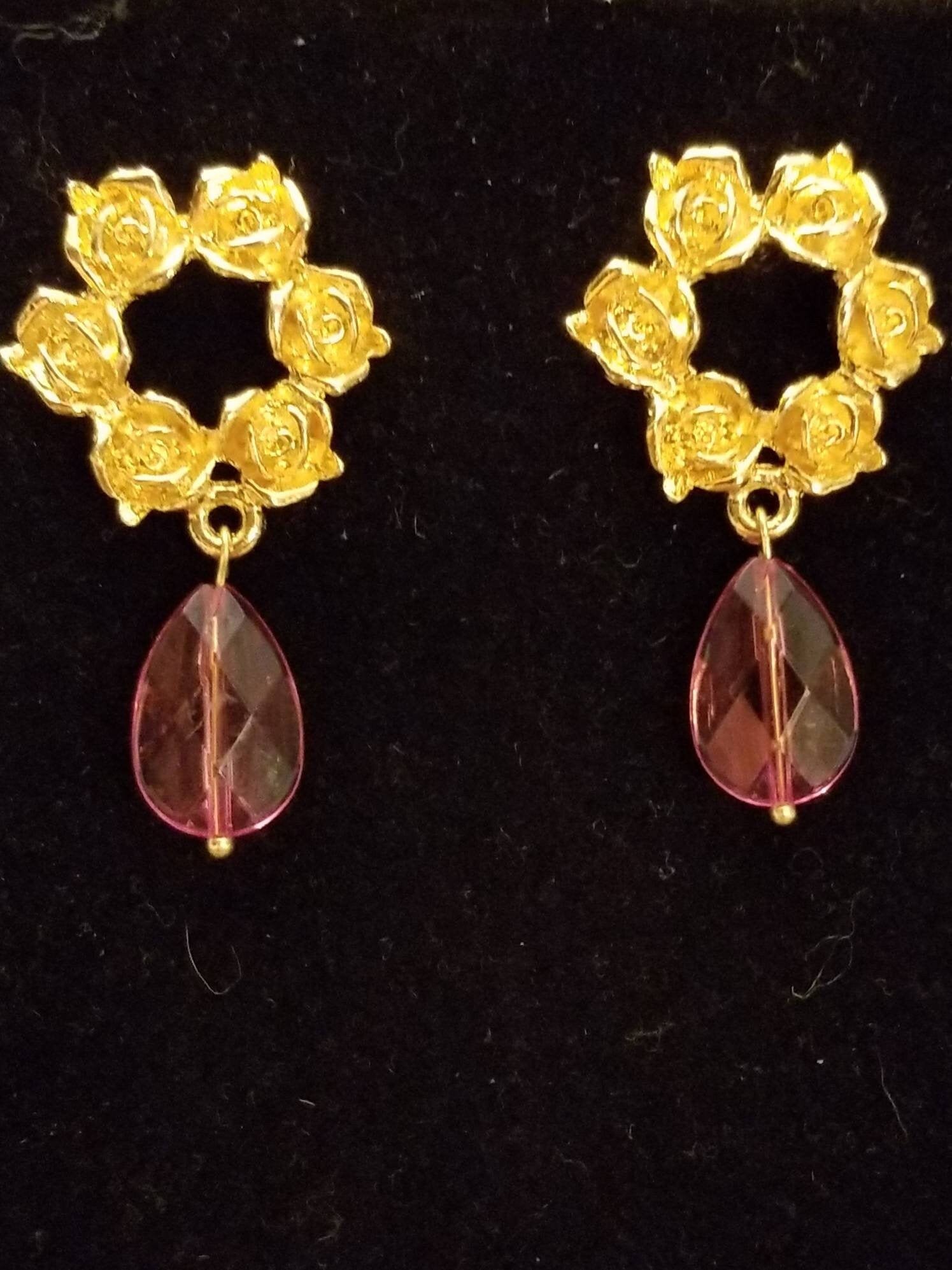 Elegant gold roses with pink teardrop earrings. A wreath of roses in gold, length with pink crystal teardrop is 2 inches.