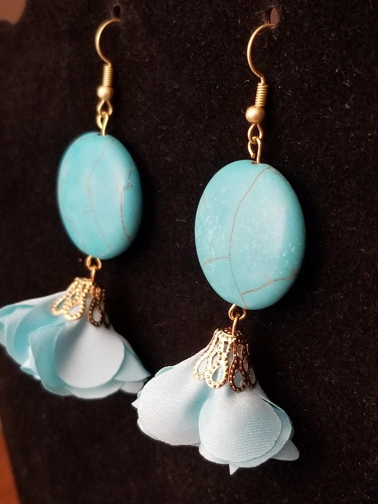 Turquoise colored dangle earrings with flirty fabric flowers.