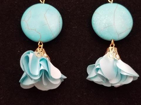 Turquoise colored dangle earrings with flirty fabric flowers.