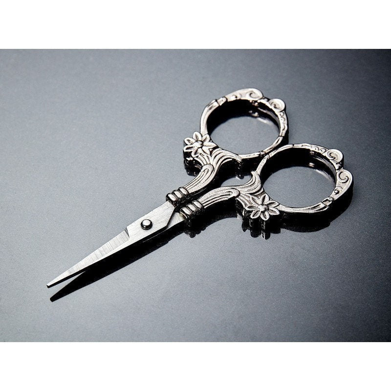 Hemline Embroidery Scissors with elegant floral and scroll motif on gunmetal black handles.