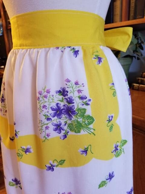 Yellow and Lavender floral half apron on white background. Made of vintage fabric.