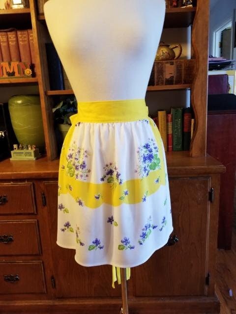 Yellow and Lavender floral half apron on white background. Made of vintage fabric.