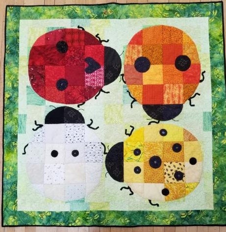 Ladybug Squared Pattern Quilt Pattern for the confident beginner by Claudia A Jakim for 46 x 46 inch quilt that is charm pack friendly